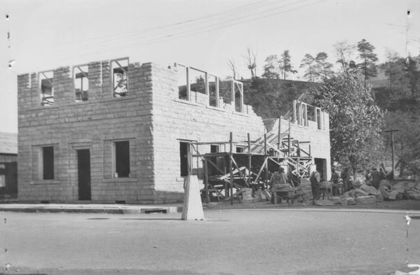 Project #30 District 4: Construction of a new City Hall at Cumberland, Harlan County, KY. This project was partly completed under E.R.A. Native sandstone used in this building is quarried on the same project from a site about .5 mile west of the city. View of the City Hall building showing workmen facing stone before laying