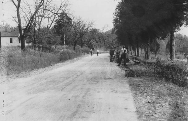 Project #249 District 6: Reconstruction of the Mt. Washington Road. This is one of the several projects on Echo Trail, a scenic highway which circles the outer edge of the county. This project involves the widening of the present 10' bituminous surface to 16'. Additional stone base will be placed and the old surface scarified before surfacing with 75 pounds per square yard treatment. Workmen lining old pavement and excavating for extra stone base