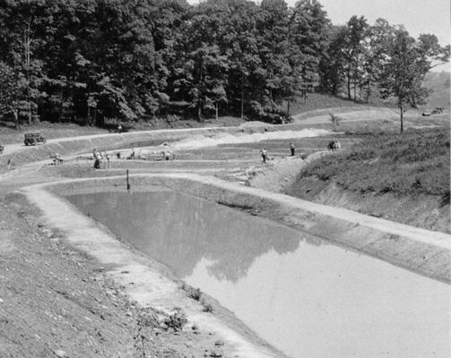 Project #2288 District 5: Project #2288 is for the building of eleven additional fish rearing pools, one lake and 1600 feet of road at the State Fish Hatchery near Ashland, KY. A fish rearing pool photographed July 8, 1936