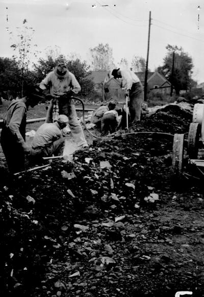 Project #105 District 1: Installation of water mains in the City of Bowling Green, KY. This project will provide a valuable addition to the city's water supply system when completed and is being carried on in a very workman like manner. The photograph shows workmen excavating solid rock for a section of the line on 13th Street