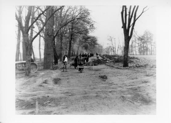 Project #897 District 6: Construction of a 20-foot cement-bound macadam re-surface on the lower River Road, Shawnee Park, Louisville, KY, which is a scenic highway along the Ohio River. Preparation of road bed on River Road, at Shawnee Park. The Ohio River may be seen on extreme left side of picture. Photographed November 15, 1935