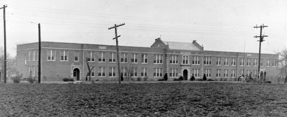 Project #168 District 1: Under Project #168, a two story brick high school building, 274 feet long by 57 feet wide, was erected at Paducah, KY. This new building, containing 21 classrooms, provides facilities for approximately 400 students. It replaces a four-room structure, totally inadequate for the needs of the community. The Heath School Building, completed May 4, 1936, is one of the most modern school buildings in the entire state. View was photographed December 19, 1936