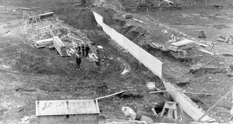 Project #2672 District 4: Construction of a reservoir at Mt. Vernon, KY, by building an earth dam across Renfro Creek. Dam will have a concrete core wall and riprap water slope. View showing dam for reservoir and concrete core wall partially completed, photographed December 15, 1936