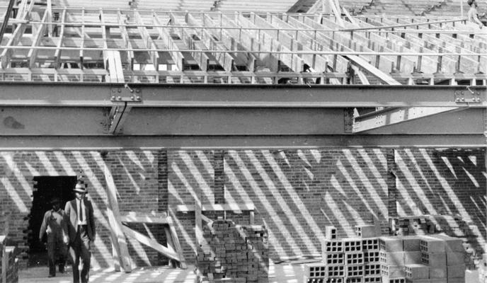 Project #2446 District 6: The construciton of a brick and tile building which will serve as a municipal library and auditorium at Franklin, KY. Interior view of the auditorium-library showing steel framing. Photograph taken September 25, 1936