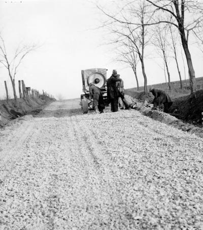 Project #117 District 2: Improvement of farm-to-market roads. Grading, draining and surfacing 0.5 miles of road beginning 0.25 miles northeast of Bloomfield and extending to Bloomfield-Fairfield Road. Portable crusher at work crushing stone for surfacing the road. Photographed December 20, 1936