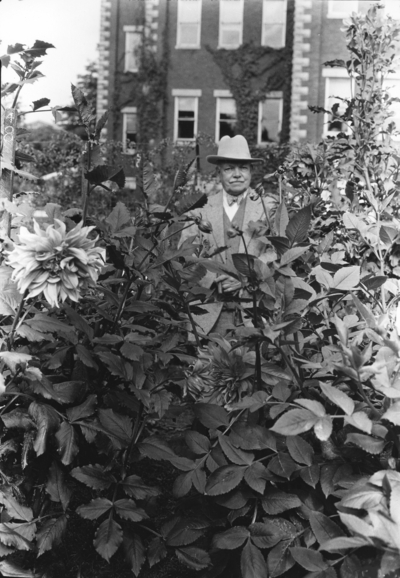 Dean F. Paul Anderson standing with the Dahlias