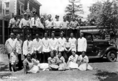 Senior Breakfast Alumni Tea, African-American servers in first row and yard workers on truck