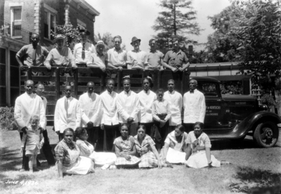 Senior Breakfast Alumni Tea, African-American servers in first row and yard workers on truck