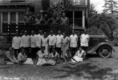 Senior Breakfast Alumni Tea, African-American servers in first row and yard workers on truck