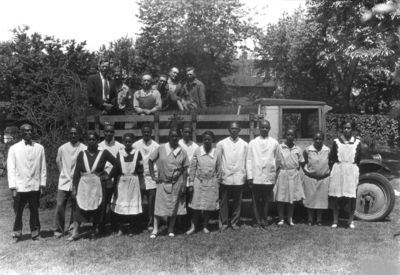 Senior Breakfast Alumni Tea, African-American servers in first row and yard workers on truck