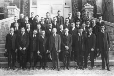 Group photograph, center Dean Columbus R. Melcher, Dean of Men and German Professor, on steps of Miller Hall on steps of Miller Hall