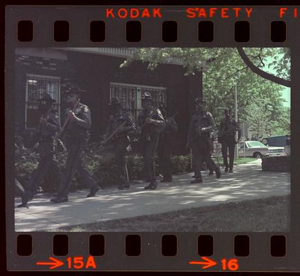 Groups of people and soldiers in front of Buell Armory