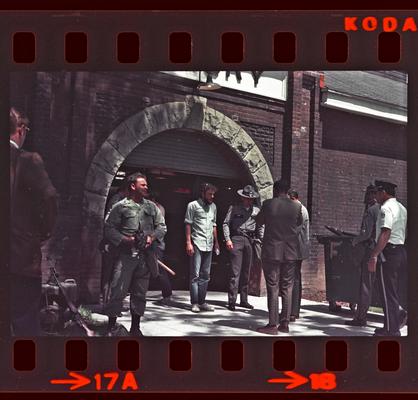 Groups of people and soldiers in front of Buell Armory