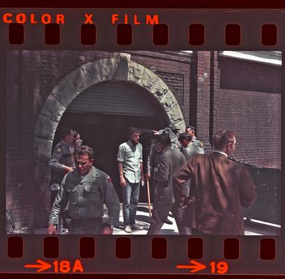 Groups of people and soldiers in front of Buell Armory