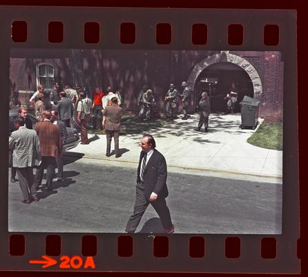 Groups of people and soldiers in front of Buell Armory