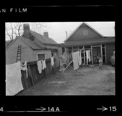 Children on bikes, Girl standing on porch, Children outside by laundry