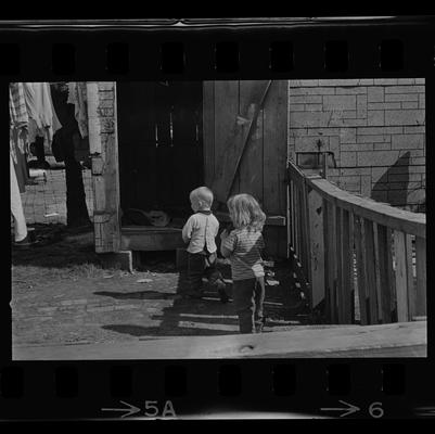 A woman and child, Two children, A child standing by door