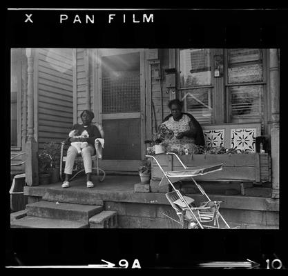 Two women on porch, Three children on porch