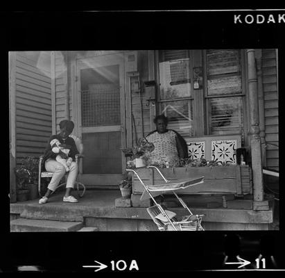 Two women on porch, Three children on porch