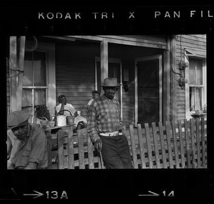 Man leaning on fence, Three children