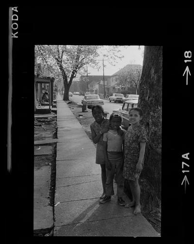 Two men on porch, Three children