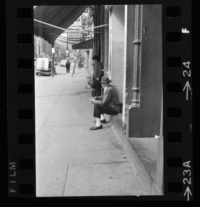 Two men in front of building, Waitress working in a cafe