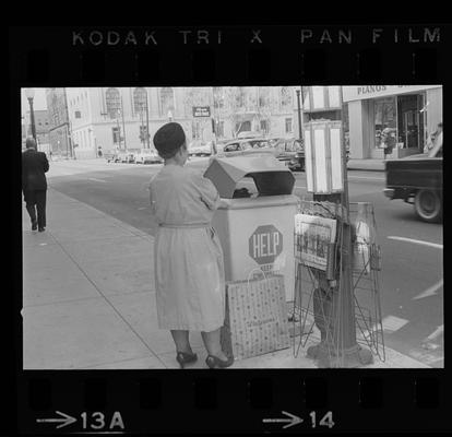 Woman throwing trash away, Nuns standing on a corner, Man standing on a corner