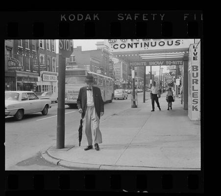 Woman throwing trash away, Nuns standing on a corner, Man standing on a corner