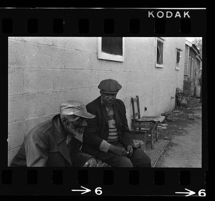 Two men seated, African-American man