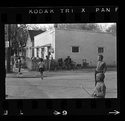 Two men seated, Child in the street