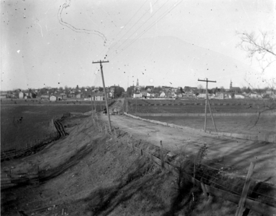 a roadway with a town off in the distance