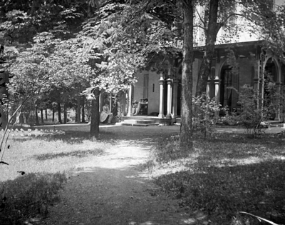 front of a house with people on the porch