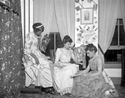 3 women who appear to be dressed in costume