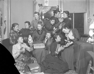 a large group of women eating bananas and being silly