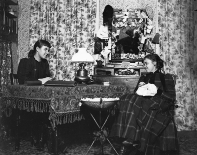 2 women sitting across a table from each other