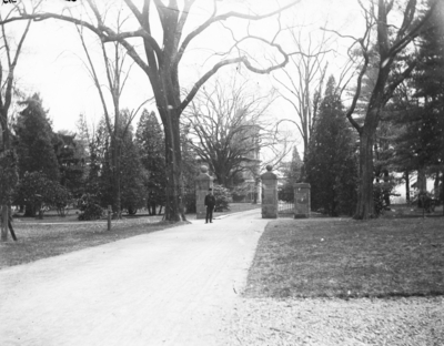 a man standing on a pathway with buildings off in the distance