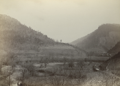 Unidentified mountain landscape with buildings in the background to the right