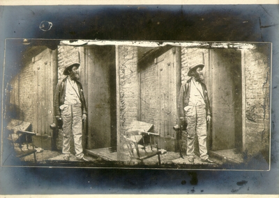 Man standing at the door of run down building