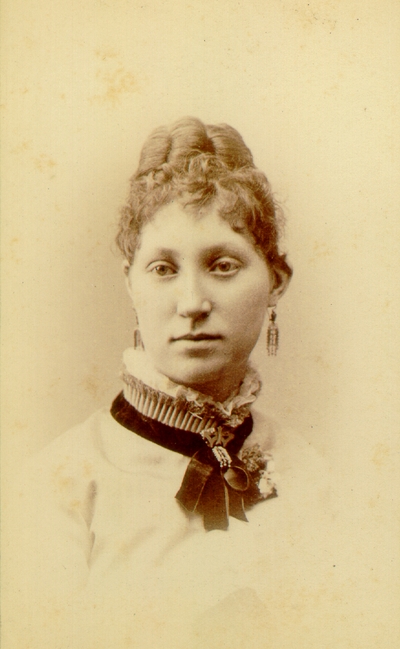 Young woman with done up hair wearing white blouse