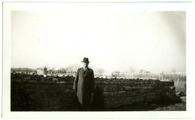 Samuel M. Wilson (1871-1946) by stone wall at Traveler's Rest