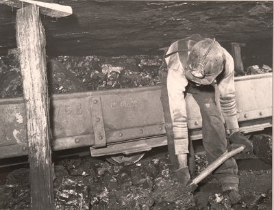 Harry Fain loading coal that has just been shot from the face.  He will load about 16-17 tons per day.  Wheelwright, Floyd County, KY. 9/24/46