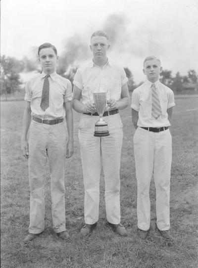 4 - H students and a trophy