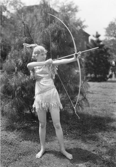 Woman in costume with bow and arrow