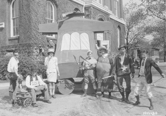 May Day, students pose in front of the float, 