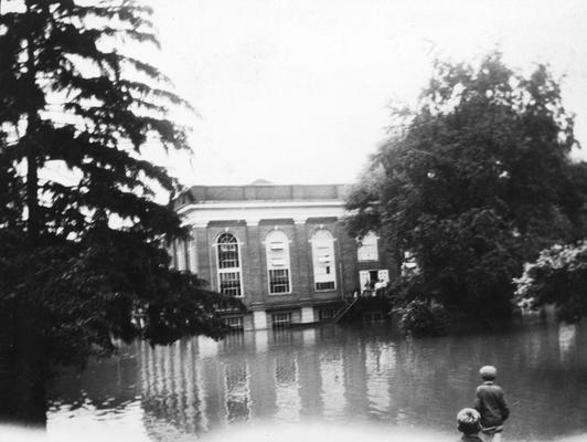 Young men wading in flood water, Alumni gymnasium, South Limestone Street, June 28, 1928