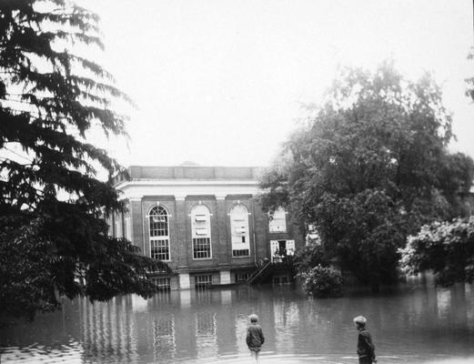 Young men wading in flood water, Alumni gymnasium, South Limestone Street, June 28, 1928