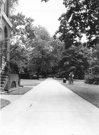 Sidewalk beside Administration Building, engineering student surveyor