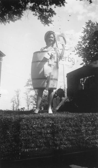 Woman on float wearing barrel, 1939