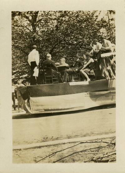 Men and women seated on a May Day float May 2, 1930