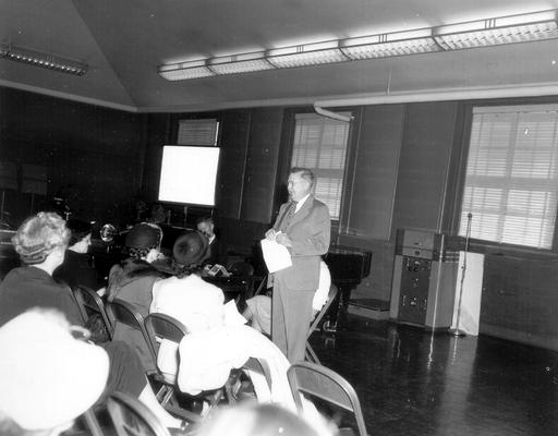 Man addressing audience of women